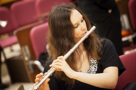 A female student plays the flute.
