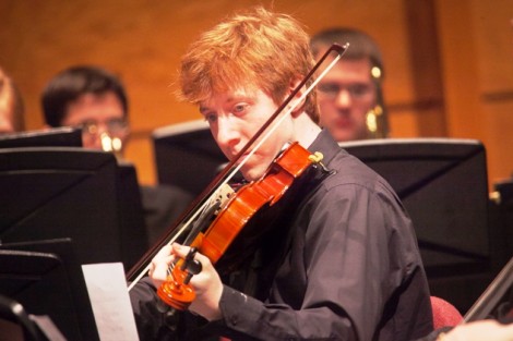 A male student plays the violin.