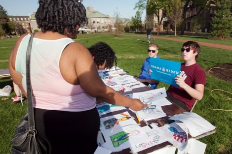 Students color drawings of President Barack Obama at the College Democrats’ table.