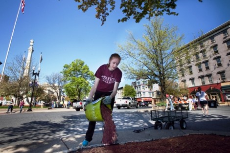 Whitney Vaughn '15 distributes mulch in downtown Easton's Center Square.