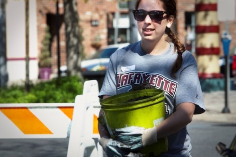 Stacy Widerman '15 carries a bucket of topsoil.