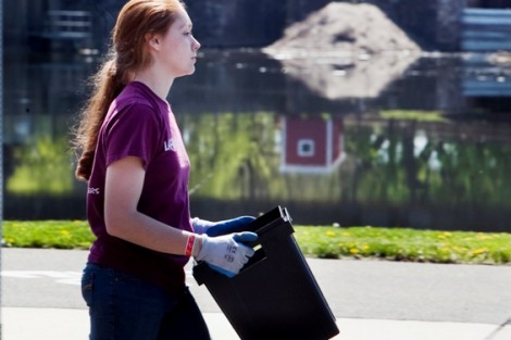 Erin Kavanagh '13 carries a container of soil down Larry Holmes Drive.