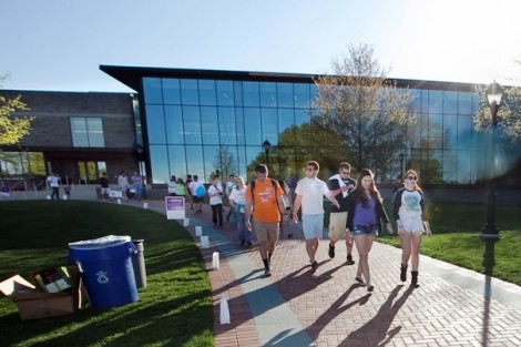Students walk with Skillman Library in the background.