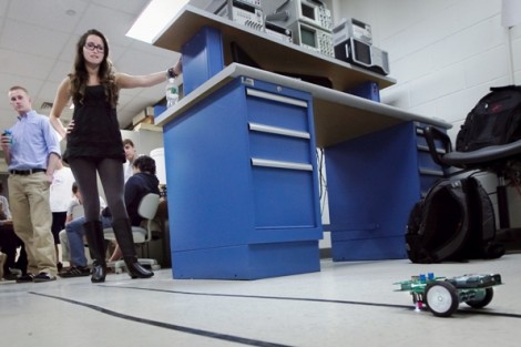 Katie Nellis ’15 watches her robot take a practice run.