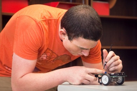 Jordan Frank ’15 repairs his robot.