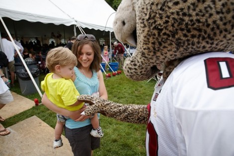 Erin North Dean ’03 introduces her son to the Leopard during the Alumni Lunch on the Quad.