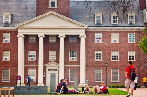 Students relax on Anderson Courtyard with Watson Hall in the background.