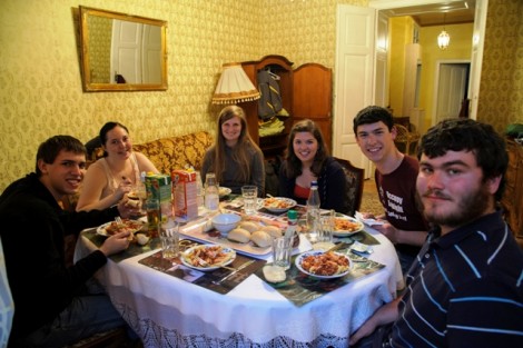 Students enjoy dinner in the apartment they rented for the weekend in Vienna, Austria.