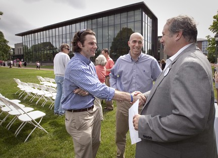 Shaw Williams '07 (far left) and Tom DiGiovanni '96 talk with Mike Whitman '82 (far right).