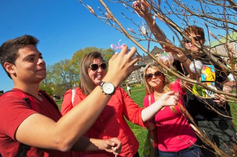 Students in a poetry class taught by Lee Upton, professor of English and writer-in-residence, place some of their poem ornaments on a tree.