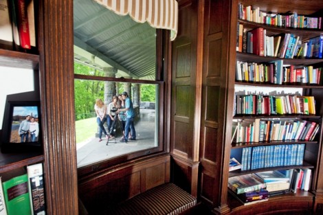 In this view through the McKelvy House library window, Kelsey Harkness '11, Jess Wason '11, Jesse Ryan '13, and Justin Chando '13 film a documentary about the history of the house and program.