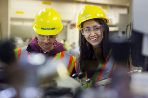 Tyler Fruneaux '14 and Christina Cucinotta '14 read a manual in the plant’s main laboratory.