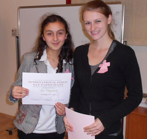 Keti Chapiashvili (left) receives a certificate recognizing her participation in the International Girls’ Day mentoring event co-created by Caitlin Lowery ’10.
