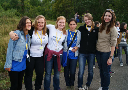 GLOW (Girls Leading Our World) Camp participants and Peace Corps volunteer counselors set out on a walk together.