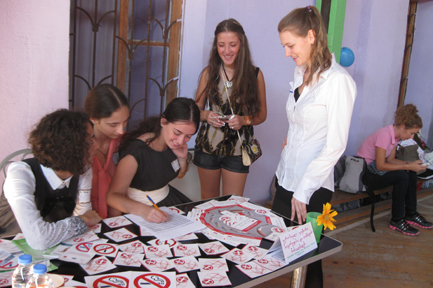 Participants at the women’s health fair held in the regional capital of Kutaisi talk with organizer Caitlin Lowery ’10 (far right).