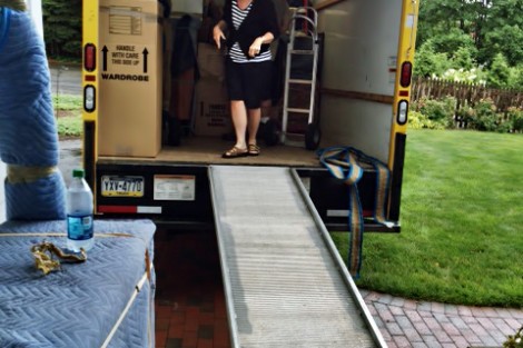 On her first offical day, Alison Byerly helps unload the moving truck.