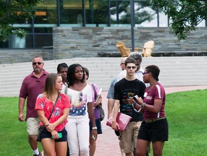 Admissions ambassador Stacey-Ann Pearson '15, right, takes a group of high school students and their families on a tour of the College.