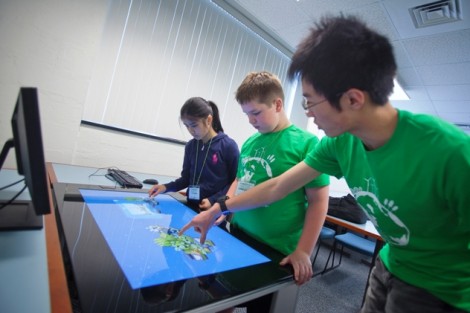 Spring You ’16 helps campers during the Future Worlds segment. The students played a video game trying to make an island completely green and sustainable.