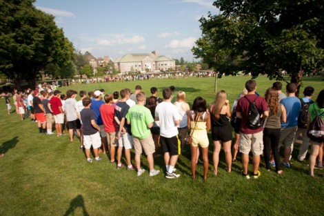 The students participate in a team-building exercise by forming a circle around the Quad.