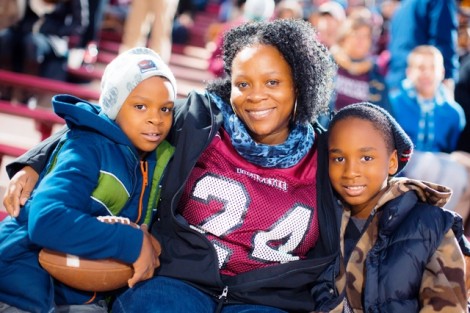 Aretha Smalley and her sons, Gabriel and Caleb, watch the game and her oldest son, Matthew '16, who wears number 24.