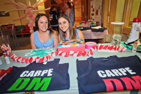 Melissa Epstein ’14, left, and Alex Lazzara ’14 sell 'Carpe DM' t-shirts and collect donations. 