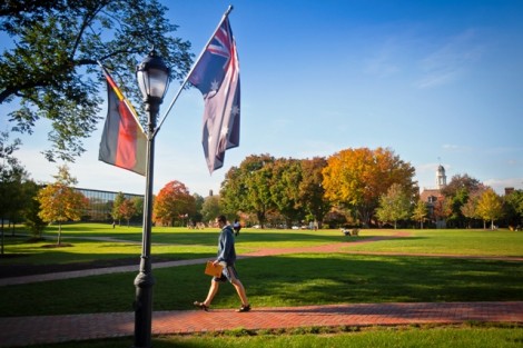 Flags representing international students on campus line the Quad.