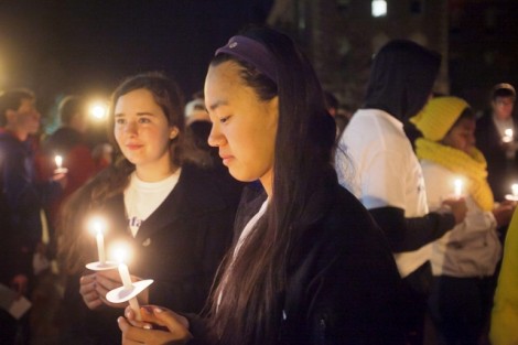 Students light candles in honor of the victims of sexual violence.