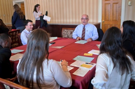 Tony Fernandez ’81 talks with students in a small group session.