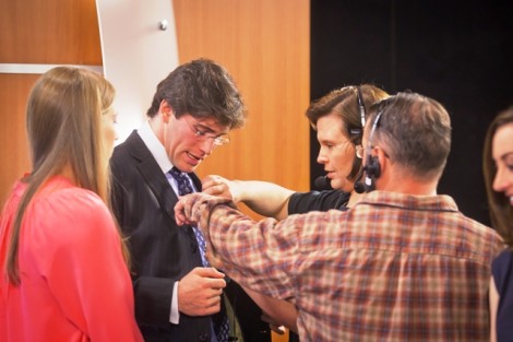 PBS crew members attach a lavalier to Reed Shapiro ’14. 