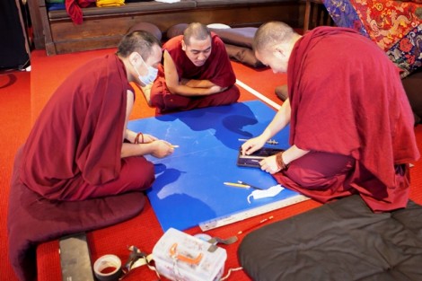 The monks prepare to build the sand mandala. 