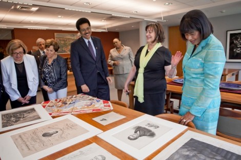 College archivist Diane Shaw, center, shows Jamaican Prime Minister Portia Simpson Miller, right, and Stephen Vasciannie, Jamaican ambassador to the U.S., items in the Special Collections office.
