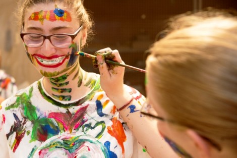 A student gets painted like a skeleton.
