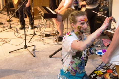 Genevieve Asselin '15  paints as The Hoochie Coochie Men play in the background. 