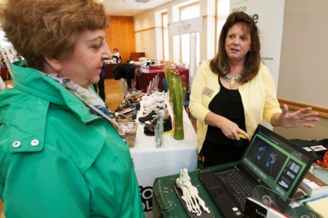 Patricia Smull, left, office assistant in development, talks with a vendor from Foot Solutions.