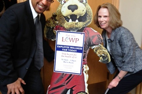 George Bright, associate director of athletics, and Linda Arra, executive director of career services, pose with the Wellness Fair leopard.