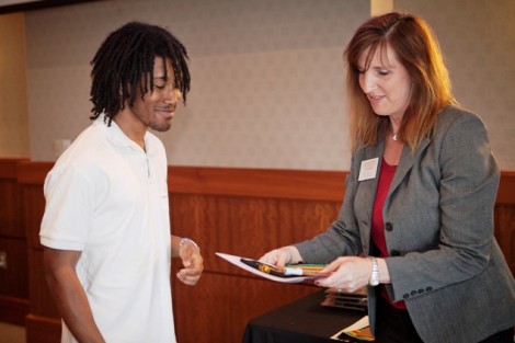 Justin Butler ’14 receives his senior gift from Kim Spang, acting vice president of development and College relations. 