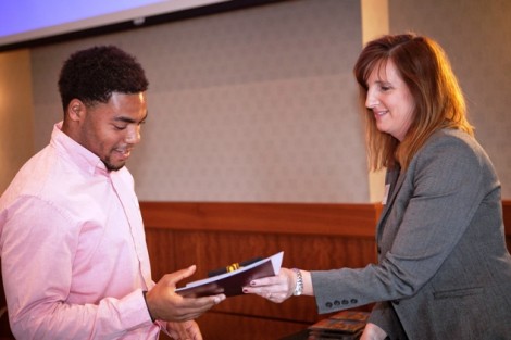 Carter Tindell-Hall ’14 receives his senior gift from Kim Spang, acting vice president of development and College relations.