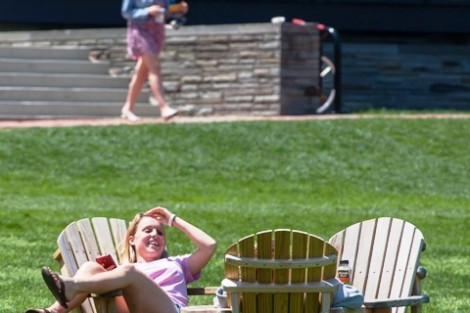 Students hang out on the Adirondack chairs on the Quad.