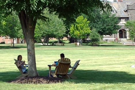 Students relax on the Adirondack chairs on the Quad.
