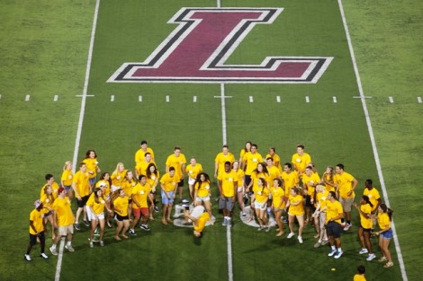 Orientation leaders perform on Fisher Field for the new students.