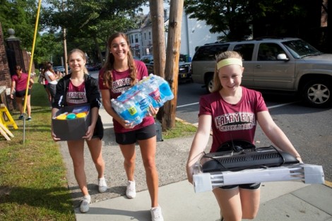 Cheerleaders help new students move in along McCartney Street.