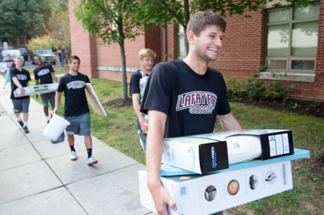 Lafayette soccer players help new students unload their things.