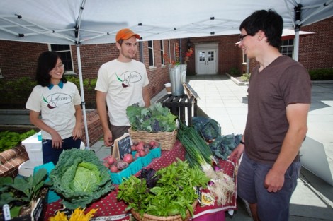 Hong Ha Vu '17 and Eric Giovannetti '15 speak with a fellow student about LaFarm.