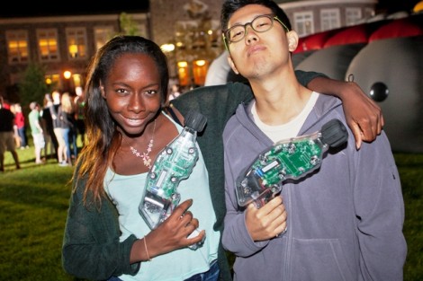 A pair of students strike a pose with their laser guns.