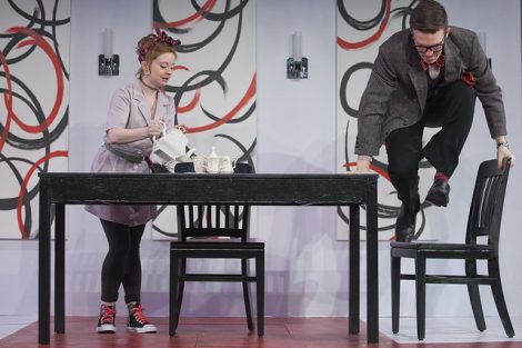 Two students act on stage in a scene from the Lafayette production of the play Tartuffe.