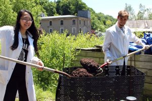 Cathy Ye '17 and Campbell Weyland '17 work with organic compost. 