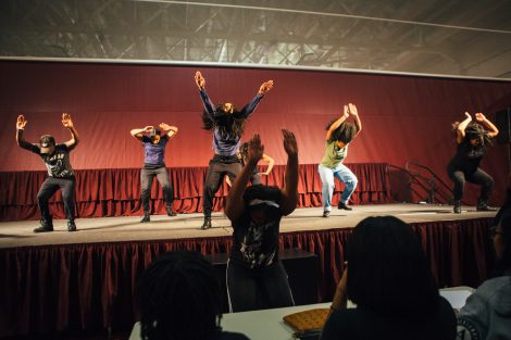 Men dancers perform on stage