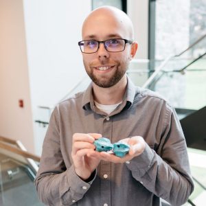 Johnathan Steffens holds silicon moldings of the inside of his mouth, made during his first research work as an undergraduate.