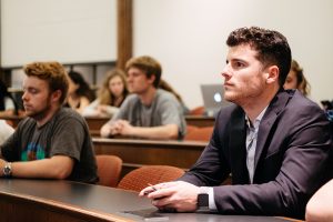 A male student listens to the lecture.