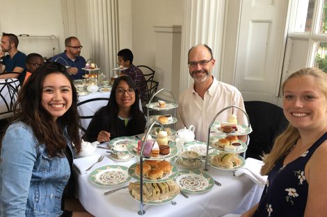 Professor Chris Ruebeck and three students at a restaurant lunch table